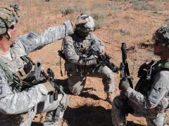 After receiving coordinates on the Nett Warrior system, U.S. soldiers from the 35th Infantry Regiment, 1st Armored Division, prepare to move out during a Network Integration Evaluation exercise.