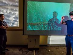 Tam Le (l) and Todd Noel, computer scientists at Sandia National Laboratories, demonstrate how augmented reality assists in nuclear material protection training.