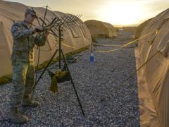 A U.S. Air Force tactical network operations technician adjusts an AV-211 antenna at Diyarbakir Air Base, Turkey. The latest networking techniques, such as software-defined wide area networks, may offer both budgetary and operational benefits for the Defense Department.