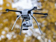 A drone operated by airmen flies over a training area at Joint Base Elmendorf-Richardson, Alaska, in October, while capturing aerial intelligence during a two-week military exercise. Software for unmanned systems goes through extensive and time-consuming testing, but machine learning could change that. Credit: Alejandro Pena, Air Force