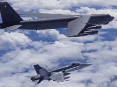 A Canadian Forces CF-18 fighter intercepts a U.S. Strategic Command B-52 bomber over Canada as part of a coordinated exercise. Northrop Grumman is being awarded a $98 million contract to operate and maintain Strategic Command’s command and control capabilities.