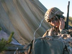 A U.S. Army paratrooper communicates by radio during a drop in Latvia. Traditional radio and network status information will play a key role in cyber situational awareness in the digital battlespace. Credit: Army photography by Spec. Dustin Biven, USA