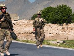 Two U.S. soldiers prepare to clear improvised explosive devices (IEDs) from a polling area in Afghanistan. Many of the processes the Joint Improvised-Threat Defeat Agency (JIDA) uses to bring useful technologies and systems to the field quickly can be applied to acquisition reform efforts throughout the U.S. Defense Department.