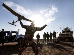 Air Force Tech Sgt. Matthew Coutts launches a Raven B Digital Data Link drone during a demonstration in Southwest Asia in January. The Navy is developing a video game-based tool to evaluate the skills of potential unmanned vehicle operators. Air Force photo by Staff Sgt. Joshua Kleinhol