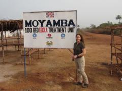 Paula Austin, a Sandia systems engineer within International Biological and Chemical Threat Reduction group, stands outside an Ebola treatment unit in Sierra Leone. (Image courtesy Sandia National Laboratories)