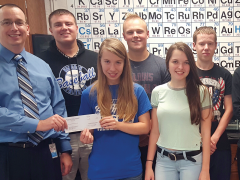 STEM teacher Ray Johnston and his Chem-Science Club students at Hancock Middle/Senior High School in Maryland show his $1,000 Gravely Grant.