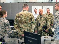 Maj. Gen John C. Harris Jr., ANG (c), the adjutant general, Ohio National Guard, observes training while the Cyber Mission Assurance Team (CMAT) conducts network assessments during exercise week of Cyber Shield 19 at Camp Atterbury, Indiana. The National Guard is standing up the teams to help secure the critical infrastructure that services U.S. Defense Department installations. U.S. Army National Guard Photo by Staff Sgt. George B. Davis