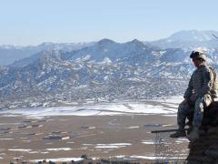 A 10th Mountain Division soldier keeps an eye out for enemy activity from an observation post outside Forward Operating Base Tillman in the Paktika province of Afghanistan. If military researchers are successful in unplugging the sensors required to provide intelligence, surveillance and reconnaissance around forward operating bases, they also might spur commercial Internet of Things technologies.