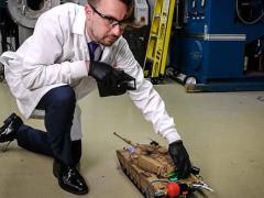 Army researcher Anthony J. Roberts powers a radio-controlled toy tank with hydrogen harvested from a unique chemical reaction. U.S. Army photo by David McNally