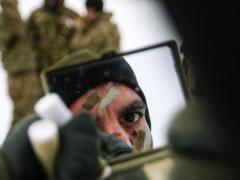 Army Sgt. K.C. Pless applies camouflage paint before a multinational weapons training session with Danish troops in Estonia on March 10 in support of support Operation Atlantic Resolve. As the Army operates in an ever-changing world, the service’s military intelligence needs to provide a counter to the evolving threats. Army photo by Spc. Hubert D. Delany III