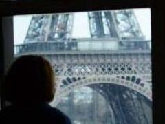 Katie Helwig, manager of small business programs at AFCEA International, looks out at the Eiffel Tower. She and her family lived in Paris before returning to the United States 16 months ago. Photo by Chuck Helwigi.