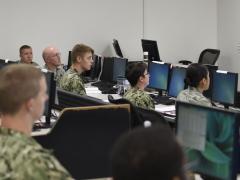 Rear Adm. Timothy White, USN, commander, Cyber National Mission Force, U.S. Cyber Command, shares feedback with students attending the Joint Cyber Analysis course at the Information Warfare Training Command (IWTC), Corry Station, Pensacola, Florida. The Unified Platform will assist members of all services in securing networks by enabling cyber warriors to prosecute full-spectrum cyberspace operations. Credit: Glenn Sircy/Center for Information Warfare Training Public Affairs