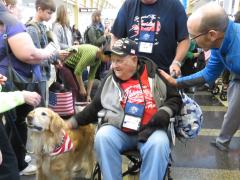 People young and old—and even golden retriever Biscuit—reached out to welcome World War II and Korean War veterans arriving at Reagan National Airport as part of the Honor Flight program.