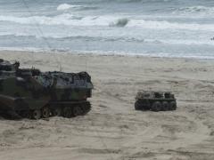 An unmanned aerial vehicle launches from a multi-utility tactical transport vehicle after exiting an autonomous amphibious assault vehicle during Ship-to-Shore Maneuver Exploration and Experimentation Advanced Naval Technology Exercise 2017. U.S. Navy photo by John F. Williams