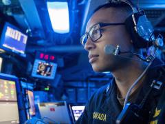 A U.S. Navy lieutenant stands watch in the command control center aboard an amphibious transport dock ship as part of the Boxer Amphibious Ready Group and 11th Marine Expeditionary Unit team. The Navy and the Marine Corps are undertaking a rebuild of their information technology capabilities in the face of increased global threats.