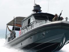 A U.S. sailor of Coastal Riverine Squadron 10 mans a crew-served weapon aboard a patrol boat in the Gulf of Tadjoura, Djibouti. (U.S. Navy photo)