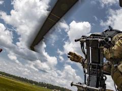 Technical Sgt. Brandon Middleton, USAF, tosses a smoke grenade from an HH-60G Pave Hawk helicopter during training at Moody Air Force Base, Georgia, in June. Increased real-time battlefield data, improved processing capabilities and the need for rapid action call for the increased use of agile software development.