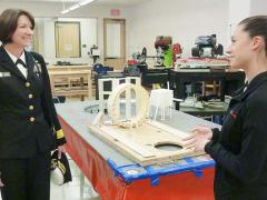 A high school student explains her team's hovercraft project to Rear Adm. Nancy Norton, USN, while Norton visits the Engineering and Aerospace Sciences Academy (EASA) in McMinnville, Oregon.