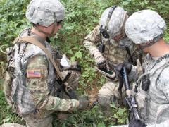 Soldiers from the Fort Benning, Georgia, Experimental Force, Alpha Company, 1st Battalion, 29th Infantry Regiment, assess capabilities on mobile devices during a field-based risk-reduction event at Joint Base McGuire-Dix-Lakehurst in New Jersey.