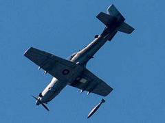 An A-29 Super Tucano drops a bomb.
