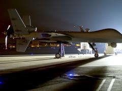 An MQ-9 Reaper sits on the flight line at Hurlburt Field, Florida, in 2014. The Reaper is an armed, multi-mission, medium-altitude, long-endurance remotely piloted aircraft primarily used as an intelligence-collection asset.