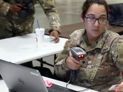 Spc. Damaris Vazquez, USA, an orderly room clerk with 90th Human Resources Company, Special Troops Battalion, 3rd Infantry Division Sustainment Brigade, Fort Stewart, Georgia, scans a common access card at Fort Jackson, South Carolina, to process soldiers in units assisting with Hurricane Florence relief efforts. Credit: Sgt. Elizabeth White, USA/Released