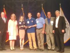 Ryan Proscia (center in dark blue) and his wife Jennifer (l) receive keys to a new home in Florida donated by Military Warriors Support Foundation, Bank of America and sponsored by Diligent Consulting.