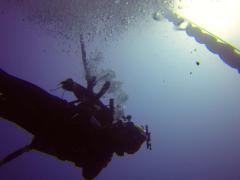 A diver descends along a deep water mooring buoy off of the coast of Guam to conduct inspection, maintenance and repair of various underwater assets.