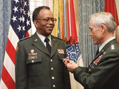 Gen. John A. Wickham Jr., USA (Ret.), then Army chief of staff (r), presents the U.S. Army's Distinguished Service Medal to Lt. Gen. Emmett Paige Jr., USA (Ret.), then commander, U.S. Army Information Systems Command, during a 1986 ceremony at the Pentagon. (Defense Department photo by Scott Davis)