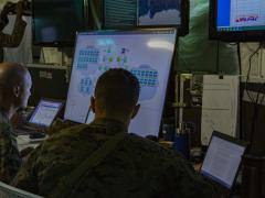 U.S. Marines assigned to the Defensive Cyberspace Operations–Internal Defensive Measures Company, 9th Communications Battalion, review network configurations in the current operations tent at Marine Corps Base, Camp Pendleton. The company executes defensive cyberspace operations for the Marine Corps Enterprise Network. Photo by Cpl. Cutler Brice, USMC, I Marine Expeditionary Force