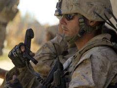 A U.S. Marine Corps sergeant performs a radio check during a security patrol in the Nawa district of the Helmand province, Afghanistan. Harris Corp. has been awarded a $1.7 billion contract to provide radios to Afghanistan under the Foreign Military Sales program.