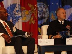 Wendell E. Foster, Jr., executive director, DODIN (l), and Rear Adm. William E. Chase III, USN, deputy commander, JFHQ-DODIN, talk about the past, present and future of JFHQ-DODIN during TechNet Cyber. Photo by Michael Carpenter