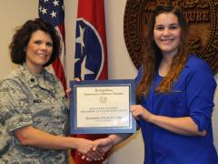 Alexandria Elizabeth Camp of the University of Memphis (r) receives an AFCEA STEM Teachers for America’s Future Scholarship from Lt. Col. Kristina M. Whicker of the Tennessee Air National Guard.