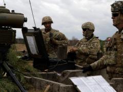 Soldiers observe an impact zone during an international exercise. The Army's PEO IEWS is developing innovative capabilities to improve battlespace-wide situational awareness as part of its effort for multidomain operations. Credit: U.S. Army photo