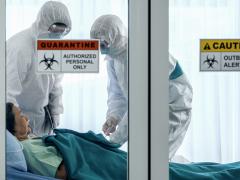A COVID-19 patient is treated in a quarantine room by health care workers garbed in personal protective equipment. The pandemic has laid bare the shortcomings in U.S. national security emergency preparedness, and experts state that only a national effort will remedy the problem. Credit: Shutterstock/Mongkolchon Akesin