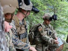 Sgt. Gabrielle Hurd, 237th Military Police Company, New Hampshire Army National Guard, shows her team the route they will take before embarking on an overnight hike to the summit of Mount Monadnock, New Hampshire, during an Enhanced Night Vision Goggle-Binocular Soldier Touchpoint in July. PEO-Soldier incorporates soldier feedback into the ENVG-B product and many others which helps the Army integrate the current needs of soldiers with the Army’s future, multidomain battlefield. Photo by Patrick Ferraris