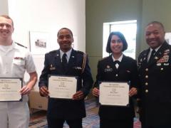 Maj. James Crenshaw, USA, secretary, AFCEA Palmetto Chapter (far r), presents ROTC Honor Awards to University of South Carolina students (l-r) Midshipman Brooks E. McNeal, Naval ROTC; Cadet Leon E. Davis, Air Force ROTC; and Cadet Aditi R. Taylor, Army ROTC.
