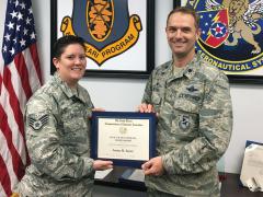 Staff Sgt. Jenna Saenz, USAF, American Military University (l), receives a 2017 War Veterans Scholarship from her commanding officer, Lt. Col. Jonathan Dietrich, USAF, 661st Aeronautical Systems Squadron.
