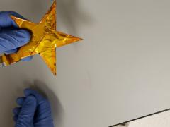 A scientist at the Army Research Laboratory (ARL) holds a demonstration battery built in the shape of an Army star. This new battery technology, constructed with a water-based electrolyte, is lightweight, flexible and safe from explosive reactions, making it more suitable for battlefield applications than conventional batteries. Army Research Laboratory photo