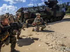 Marines exit a vehicle onto the beach during a recent amphibious landing exercise at Kin Blue Beach in Okinawa, Japan. The Marines need advanced technologies that will not limit their mobility.