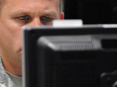 A serviceman monitors his computer during the Cyber Guard 2015 exercise. Efforts within the Defense Information Systems Agency (DISA) may lead to defense personnel receiving a cybersecurity lesson every time they log on to a military network.