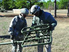 Two signal soldiers set up an antenna at a training site in Fort Gordon, Georgia. Keeping signaleers up-to-date is a primary challenge, as the development of new technologies is outpacing the ability to train.