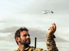 A NATO soldier launches a Prox Dynamics PD-100 nanocopter. The U.S. Army is using the system as a surrogate while developing the Cargo Pocket Intelligence, Surveillance and Reconnaissance system.