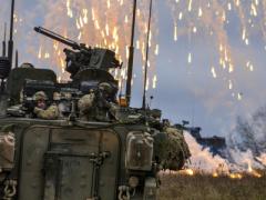 Soldiers attack simulated enemy combatants during a training exercise in Germany. Army researchers are integrating voice recognition into computing systems mounted onto vehicles with intercoms that allow soldiers to communicate in combat conditions.