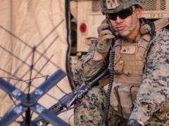 U.S. Marine Corps Cpl. Frankie Garcia, a radio chief with the 11th Marine Expeditionary Unit, calls for a radio check using a PRC-117G radio at Marine Corps Base Camp Pendleton, California. The Corps fielded a Mobile User Objective System waveform, which encompasses updated firmware to the AN/PRC-117G and an antenna kit to enhance satellite communication on the battlefield. Now, the military is developing elements of a new Fighting SATCOM architecture with some prototypical capabilities to be delivered late