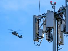 An UH-60 Blackhawk flies multiple passes at different altitudes over the runway during a series of 5G avionics tests March 2, 2022, at Hill Air Force Base, Utah. A 5G mobile test station was used during the testing as part of demonstration to implement 5G technologies without compromising the safety of military and civilian aircraft. U.S. Air Force photo by Cynthia Griggs