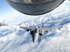 A U.S. Air Force F-15E Strike Eagle, center, a Royal Air Force F-35 Lightning II, left, and a French air force Dassault Rafale fly behind a U.S. Air Force KC-135 Stratotanker over the English Channel, during a November 2018 multinational training exercise. The Air Force is developing and fielding a new mission planning system for tankers using an agile software development methodology. Photo by Air Force Senior Airman Luke Milano