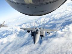 A U.S. Air Force F-15E Strike Eagle, center, a Royal Air Force F-35 Lightning II, left, and a French air force Dassault Rafale fly behind a U.S. Air Force KC-135 Stratotanker over the English Channel, during a November 2018 multinational training exercise. The Air Force is developing and fielding a new mission planning system for tankers using an agile software development methodology.  Photo by Air Force Senior Airman Luke Milano