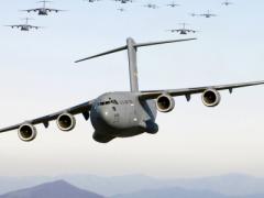 Thirteen C-17 Globemaster III aircraft fly over the Blue Ridge Mountains in Virginia during low-level tactical training. U.S. Transportation Command, which mobilizes troops and equipment around the world, is moving its cyber and command and control systems to a commercial cloud environment. U.S. Air Force photo by Staff Sgt. Jacob N. Bailey, USAF