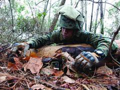 U.S. Marine Corps Lance Cpl. Ariel Tolentino, a sensor surveillance operator, conceals two cameras on the ground during an operational check at Camp Lejeune, N.C. The U.S. Army Research Laboratory is developing isotope-powered batteries that could allow unattended ground sensors to continue operating for far greater periods that today’s chemical batteries will allow.
